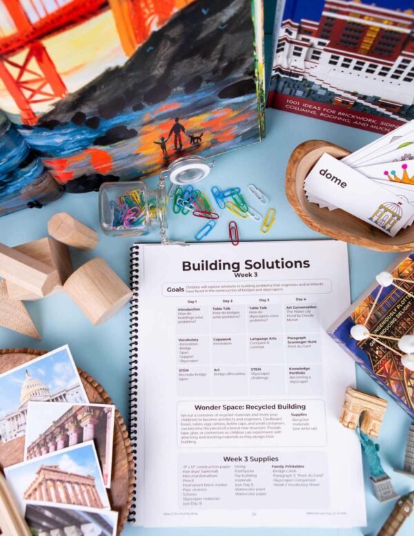 2026-Susie-2444 Lesson plan pages in a homeschool curriculum surrounded by picture books, vocabulary cards and wooden blocks,