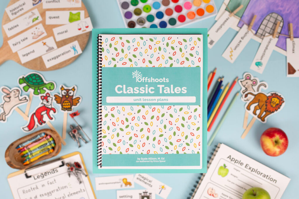 Overhead shot of a printed curriculum on blue paper with various storybook characters and school supplies in the background